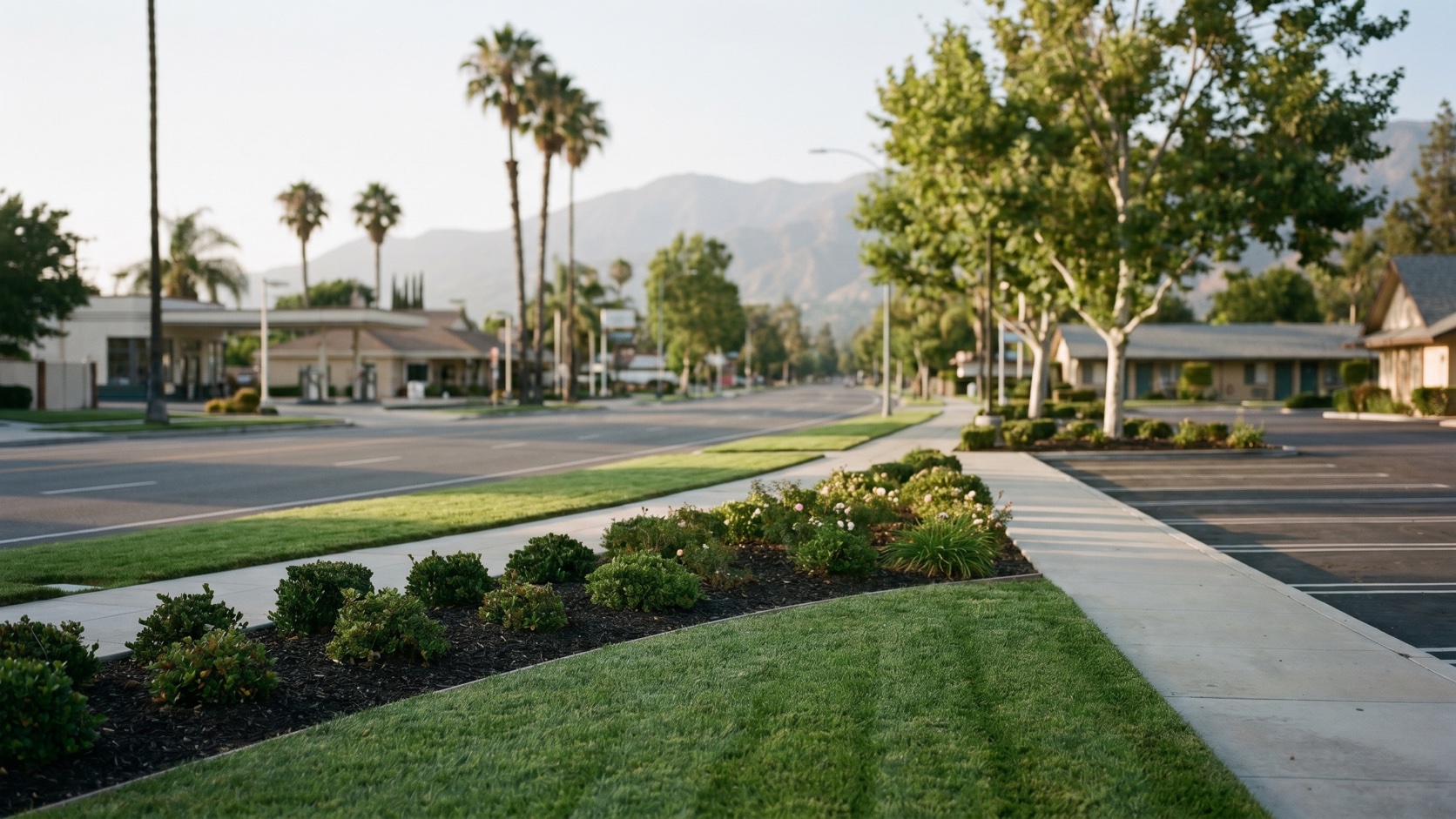 Historic Route 66 commercial corridor along Foothill Boulevard in Rancho Cucamonga with mountain backdrop and clean landscaped frontage