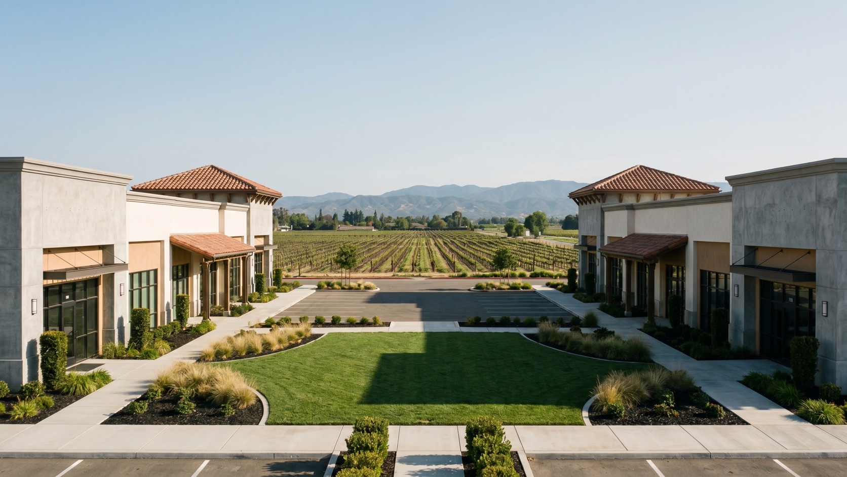 Pristine commercial plaza landscape maintained by ManageMowed in Rancho Cucamonga at golden hour with old vineyard rows in the distance